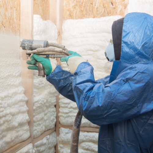 man spraying insulating spray on a wall mattoon il