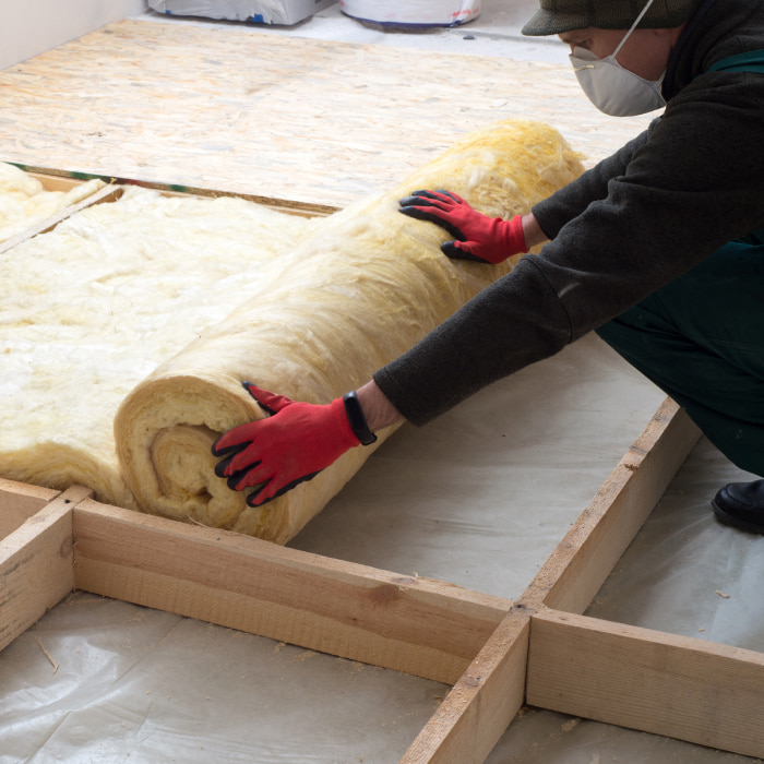 rolled insulation material being prepared by worker mattoon il