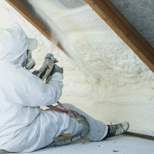 worker with safety gear spraying insulation foam at ceiling mattoon il